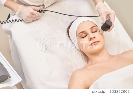 Female caucasian young adult receiving facial treatment in spa 133252002