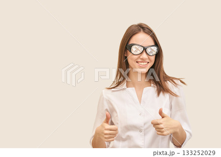 Smiling young caucasian female in white shirt giving thumbs up with stylish Smiling young caucasian female in white shirt giving thumbs up with stylish 133252029