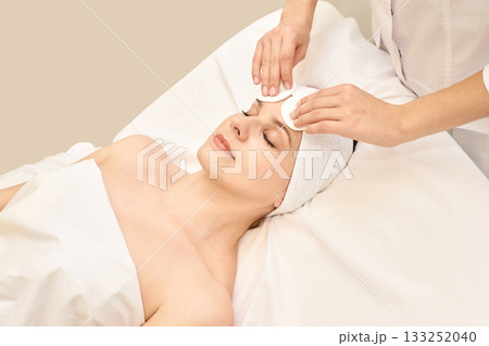 Young caucasian female receiving skincare treatment at spa with relaxing 133252040