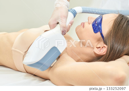 Young caucasian female undergoing professional laser hair removal treatment Young caucasian female undergoing professional laser hair removal treatment 133252097