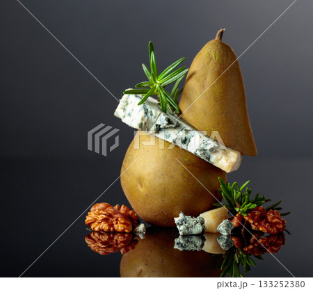 Blue cheese with pear, walnuts, and rosemary. 133252380