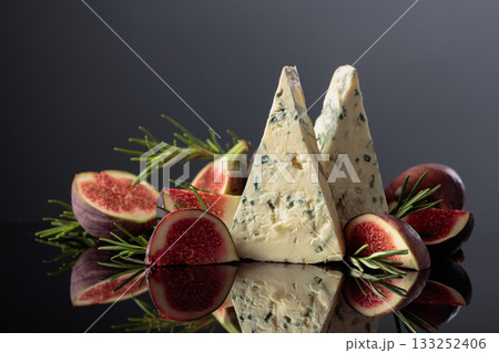 Blue cheese with fresh figs and rosemary on a black background. 133252406