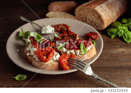 Ciabatta with sun dried tomatoes in olive oil, ricotta, and basil. Ciabatta with sun dried tomatoes in olive oil, ricotta, and basil. 133252414