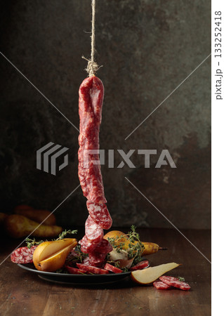 Dry-cured sausages with thyme and pears. Dry-cured sausages with thyme and pears. 133252418