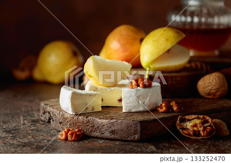 Camembert cheese with pears, walnuts, and honey. Camembert cheese with pears, walnuts, and honey. 133252470