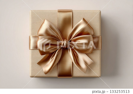 Birthday gift. Gold box wrapped with a bow on white background. Jewelry, birthdays, Christmas and luxury branding. 133253513