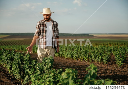 View from the front of him. Farmer is on the agricultural field 133254678