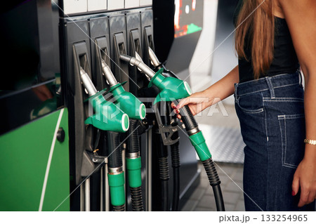 Focused detailed close up view. Young woman on the gas station 133254965