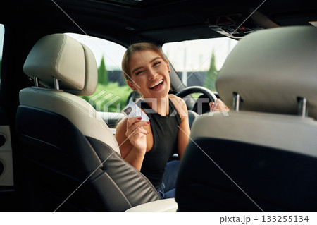 Got driver's license. Woman is sitting in the car Got driver's license. Woman is sitting in the car 133255134