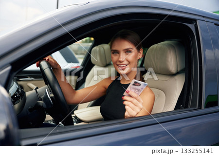 Woman is sitting in the car Woman is sitting in the car 133255141