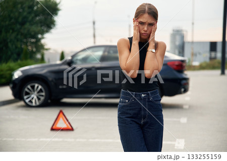 Feeling bad. Woman's car is broken, accident, standing outdoors 133255159