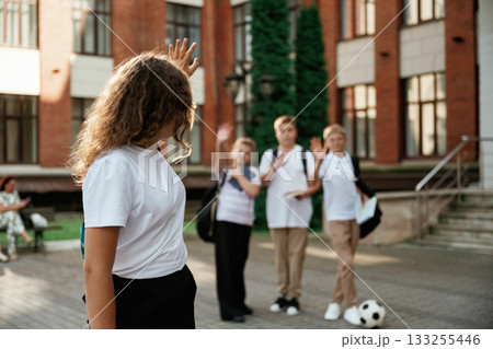 Standing and posing. Kids are near the school together, pupils Standing and posing. Kids are near the school together, pupils 133255446