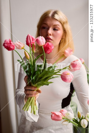 Casual stylistic scene featuring cheerful flower enthusiast Casual stylistic scene featuring cheerful flower enthusiast 133255977