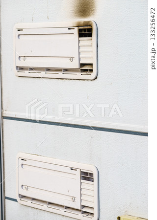 Camper car detail. Grid, ventilation plate for fridge with smoke Camper car detail. Grid, ventilation plate for fridge with smoke 133256472