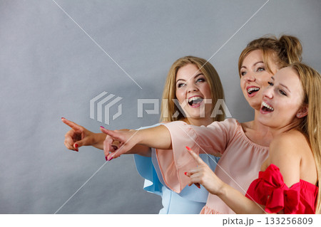 Three fashionable females pointing 133256809