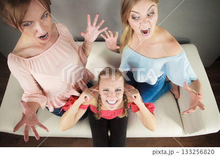 Woman being bullied by two females Woman being bullied by two females 133256820
