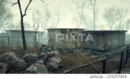 In a serene yet eerie setting, old buildings stand in decay, surrounded by bare trees. A thick mist cloaks the scene, evoking feelings of nostalgia and mystery from a lost era. 133257804