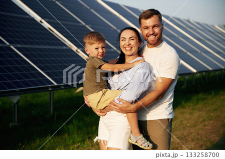 Father, mother and little son are outdoors near solar panels Father, mother and little son are outdoors near solar panels 133258700