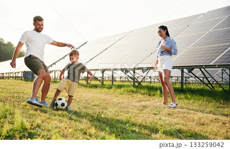 Father, mother and little son are outdoors near solar panels Father, mother and little son are outdoors near solar panels 133259042