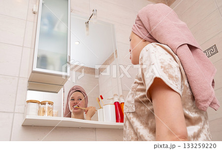 Woman brushing tooth. Morning routine and personal hygiene in bathroom. 133259220