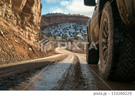 Off-Road Adventure on a Dusty Path with Scenic Rocky Mountain Landscape in Background 133260229