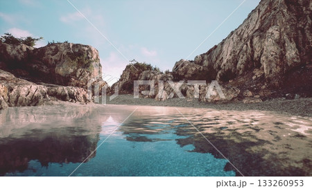Rocky cliffs frame a serene lagoon, reflecting the azure sky and surrounded by vibrant vegetation. This peaceful setting invites relaxation and nature appreciation, perfect for exploration. 133260953