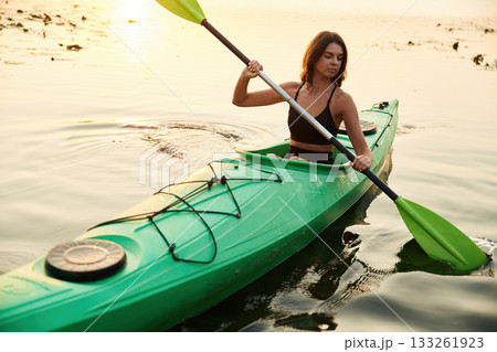 Learning process, joy. Young woman is with the sup board on the lake 133261923
