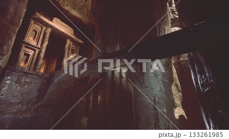 Mysterious caves reveal stunning rock formations and ancient artifacts illuminated by soft light. Shadows play across the surface, creating a mesmerizing atmosphere of discovery and adventure. 133261985