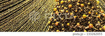 Christmas tree decorating golden balls and garland lights blurred background New Year holidays copy space 133262055