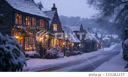 A quaint village house decorated with candles in the windows and snow lightly falling. . A quaint village house decorated with candles in the windows and snow lightly falling. . 133262237