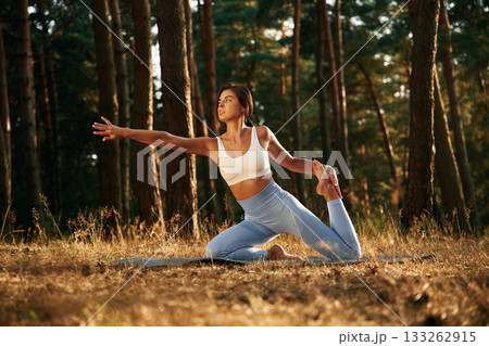 Stretching exercises. Woman is doing yoga fitness exercises in the forest 133262915