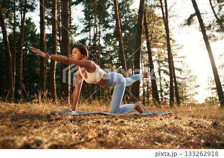 Stretching exercises. Woman is doing yoga fitness exercises in the forest 133262918