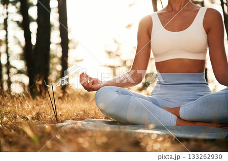 Time for calm meditation. Woman is doing yoga fitness exercises in the forest 133262930