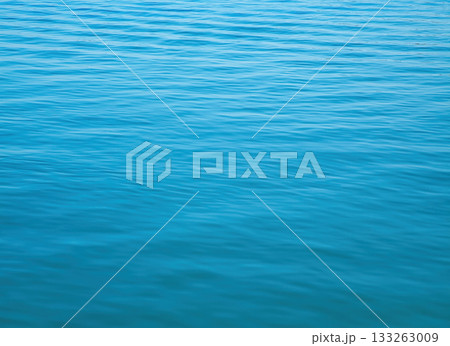 Calm river surface reflecting light in peaceful, serene natural setting Calm river surface reflecting light in peaceful, serene natural setting 133263009