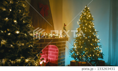 Christmas Trees Near the Fireplace in the Room Illuminated Cozy Atmosphere 133263431
