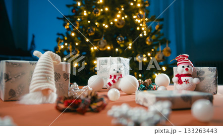Christmas table with ornaments, puppets and gifts for children 133263443