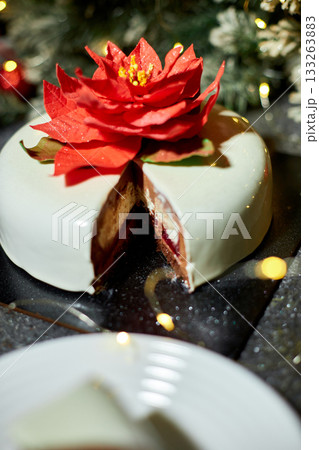 Celebratory Dessert Featuring Layered Cake With Red Velvet, Cream Cheese, and Festive Decorations in a Cozy Setting 133263883