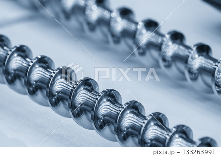 Close up scene body of the barrel screw of injection machine spare parts in the light blue scene. 133263991