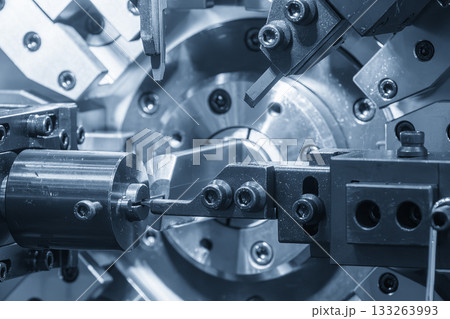 Close up scene operation of the coil spring making machine in the blue tone scene. Close up scene operation of the coil spring making machine in the blue tone scene. 133263993