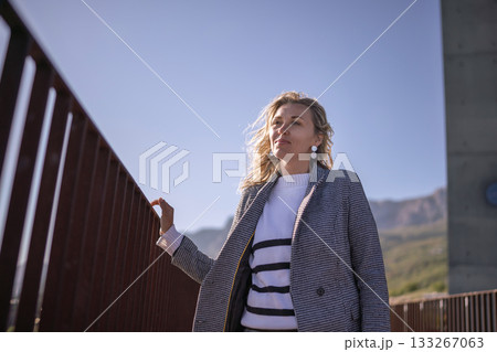 Woman view railing confident blonde stands against bright blue sky copy space Woman view railing confident blonde stands against bright blue sky copy space 133267063
