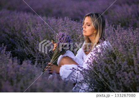 Lavender Field Woman Serenity: Sunset Portrait, Tranquil Pose, Purple Flowers. 133267080