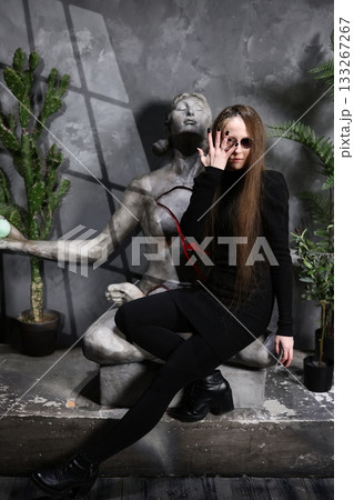 Female specialist meticulously adjusts her eyewear near historic art piece Female specialist meticulously adjusts her eyewear near historic art piece 133267267