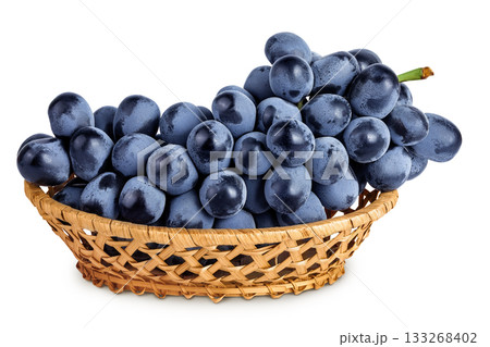 dark blue grape berry bunch in a wicker basket isolated on white background 133268402