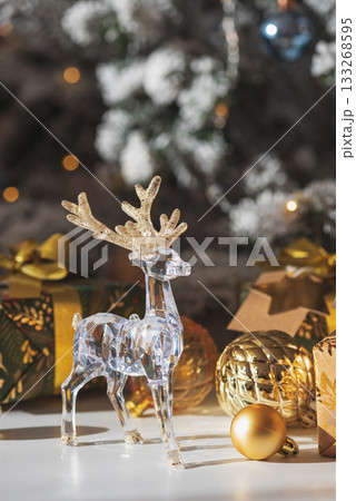Crystal Reindeer with Gold Antlers and Christmas Gifts in Festive Interior Crystal Reindeer with Gold Antlers and Christmas Gifts in Festive Interior 133268595