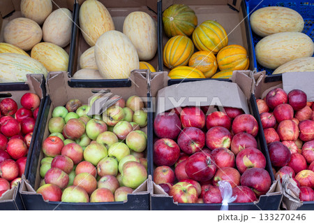 d apples, orange citrus fruits, and fragrant melons are displayed in crates at a fruit market. A colorful display d apples, orange citrus fruits, and fragrant melons are displayed in crates at a fruit market. A colorful display 133270246