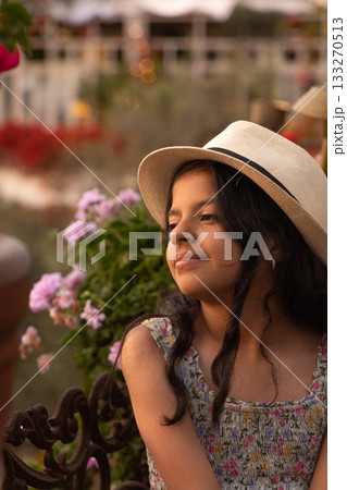 Little latin girl with straw hat and dress 133270513