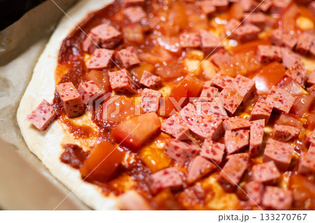 Homemade Pizza with Sausage and Tomato on Baking Tray, Cooking Process 133270767