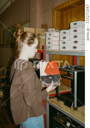 3D printers, production of three-dimensional toys at factory. female engineer programs 3D printers. 133271047