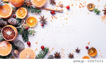 A white background with a bunch of oranges and spices. Scene is warm and inviting. Place for text. 133271111