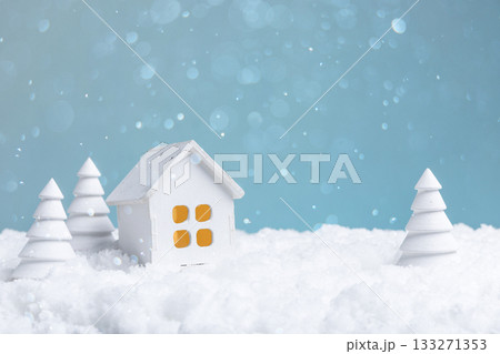 idyllic winter setting showcasing litup house surrounded by softly piled snow and pine shadows 133271353